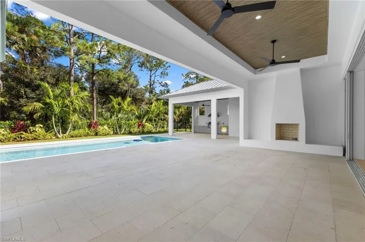 Covered lanai with gas fireplace for outside living.