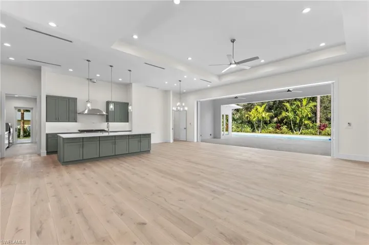 Open concept Great Room, kitchen and dining area. Gas range hood is not completed yet as well as pot filler faucet.