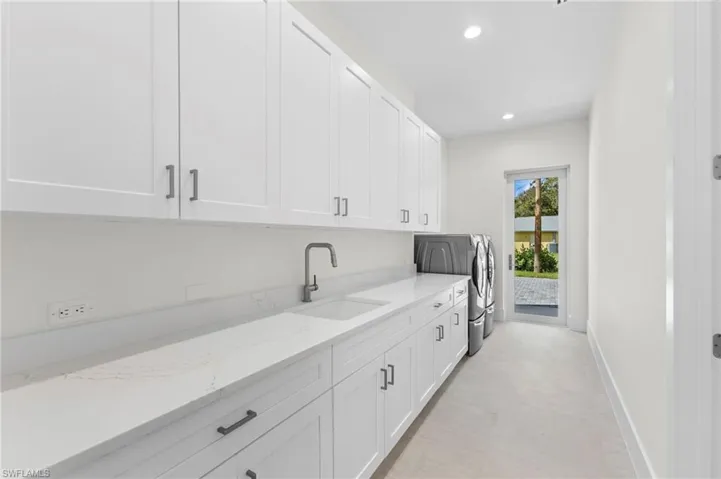 Laundry with door to garage courtyard. Butlers kitchen or pantry to the right.