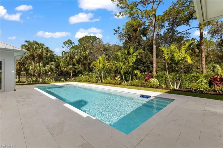 Large swimming pool with natural stone deck.