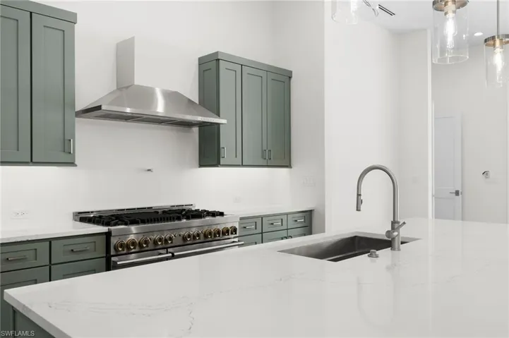 Gas range hood is not completed yet as well as pot filler faucet.