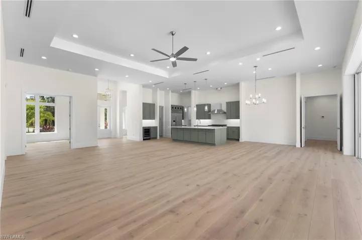 Open concept Great Room, kitchen and dining area. Gas range hood is not completed yet as well as pot filler faucet.