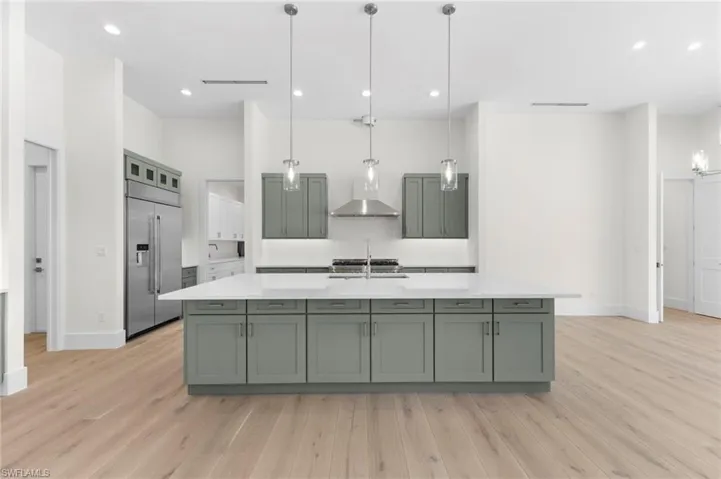 Gas range hood is not completed yet as well as pot filler faucet.