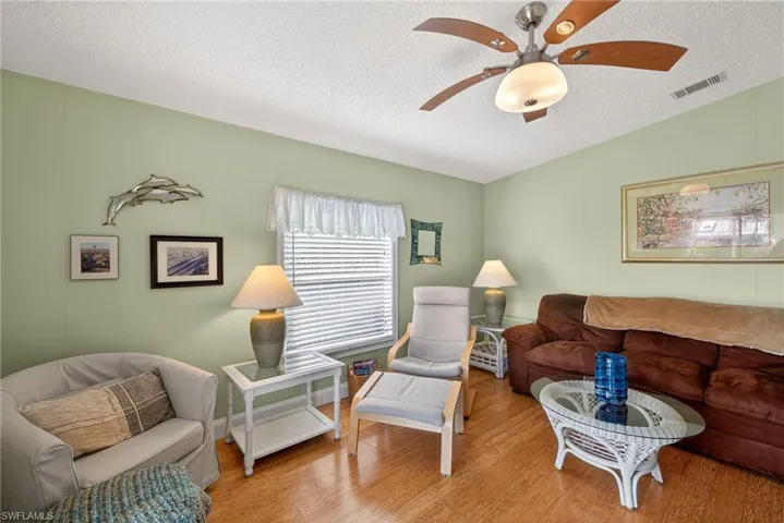 Living area featuring wood finished floors and ceiling fan