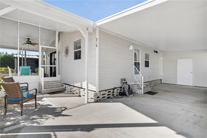 View of patio featuring entry steps, a sunroom, and a carport