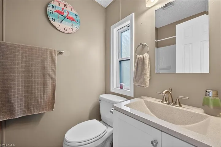 Full bath with vanity and a shower