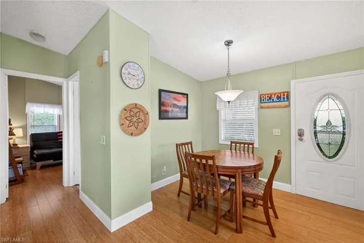 Dining space with wood finished floors and plenty of natural light