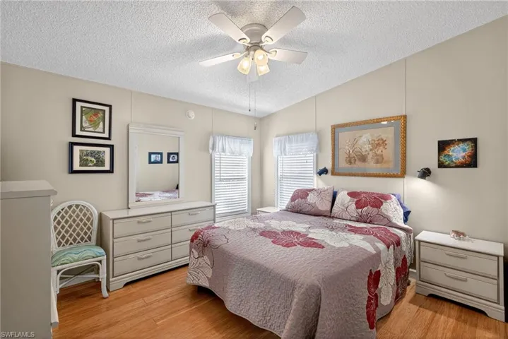 Bedroom with ceiling fan and light wood-type flooring