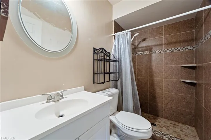 Bathroom featuring vanity and a stall shower