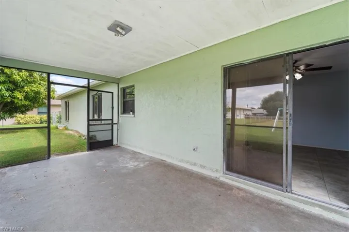 Unfurnished sunroom with plenty of natural light and ceiling fan