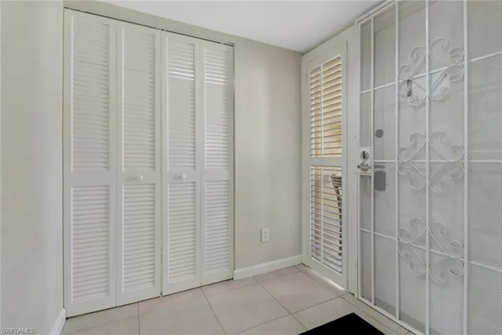 Entryway with baseboards and tile patterned floors