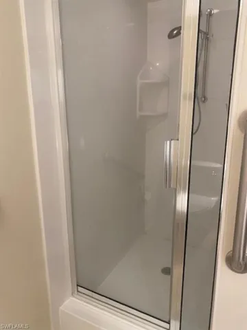 Full bathroom featuring a stall shower