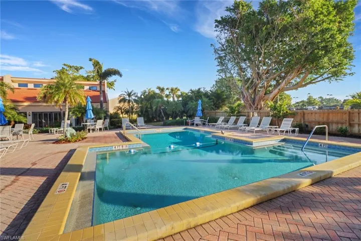 Community pool with fence and a patio