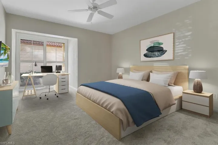 Carpeted bedroom with a ceiling fan