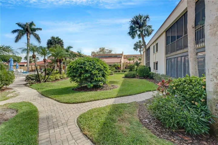 View of property's community with a lawn