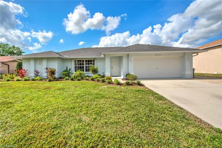 Ranch-style home featuring a garage and a front yard