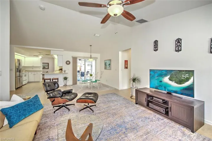 Living room with ceiling fan and vaulted ceiling