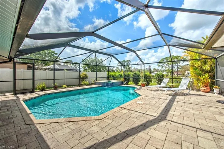 View of swimming pool featuring a lanai and a patio area