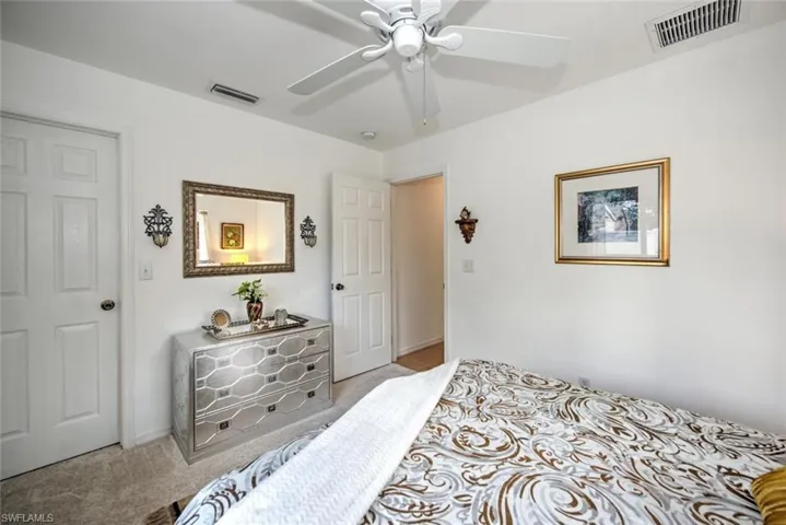 Bedroom featuring light colored carpet and ceiling fan