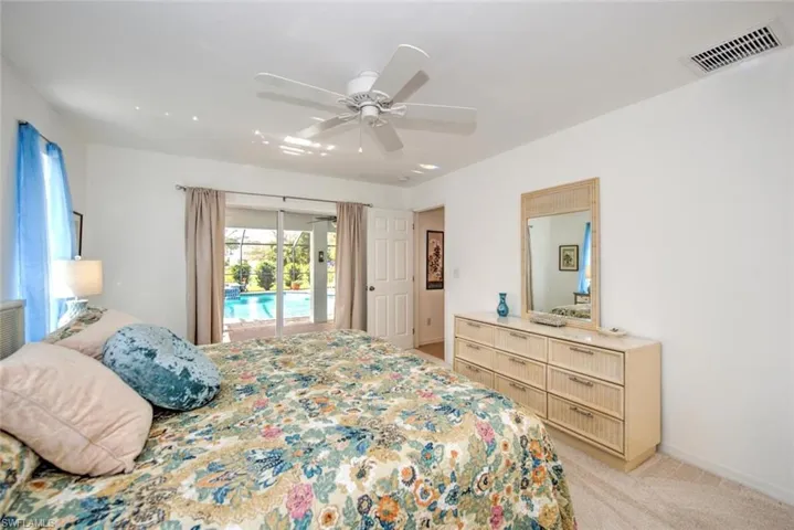 Carpeted bedroom featuring access to exterior and ceiling fan