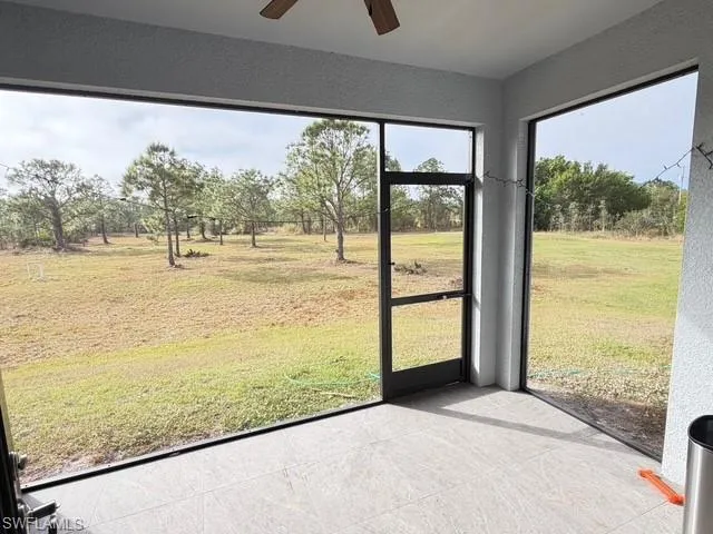 Unfurnished sunroom with a ceiling fan