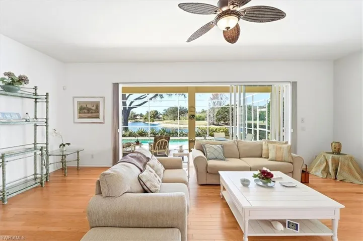 Living area with ceiling fan and light wood finished floors