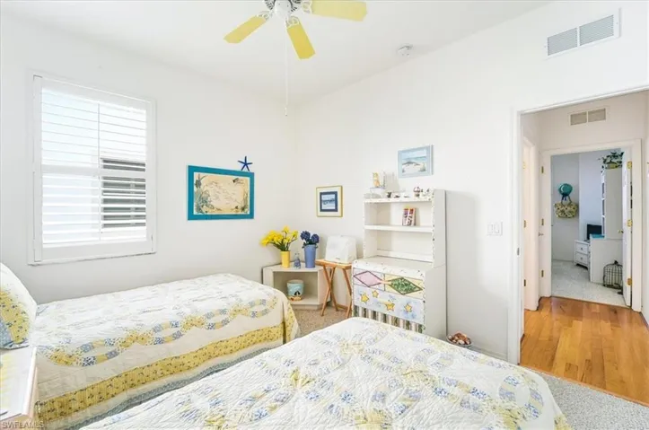 Bedroom featuring wood finished floors and ceiling fan