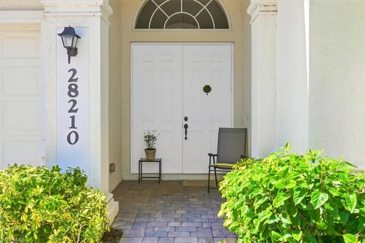 Property entrance featuring stucco siding
