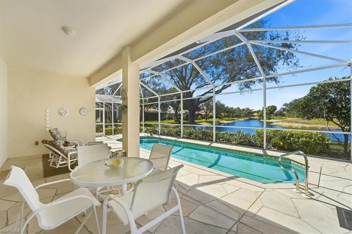 Outdoor pool with a patio, a sunroom, a lanai, a water view, and outdoor dining area