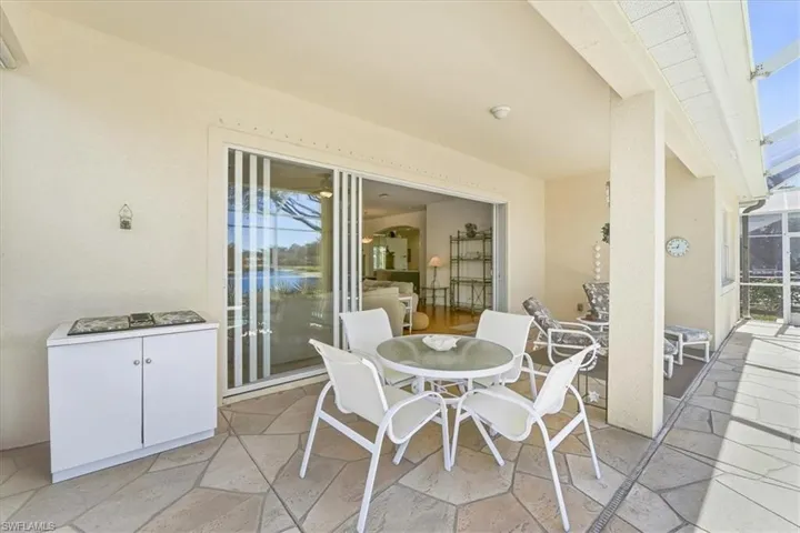 View of patio / terrace with outdoor dining space, a sunroom, and a lanai