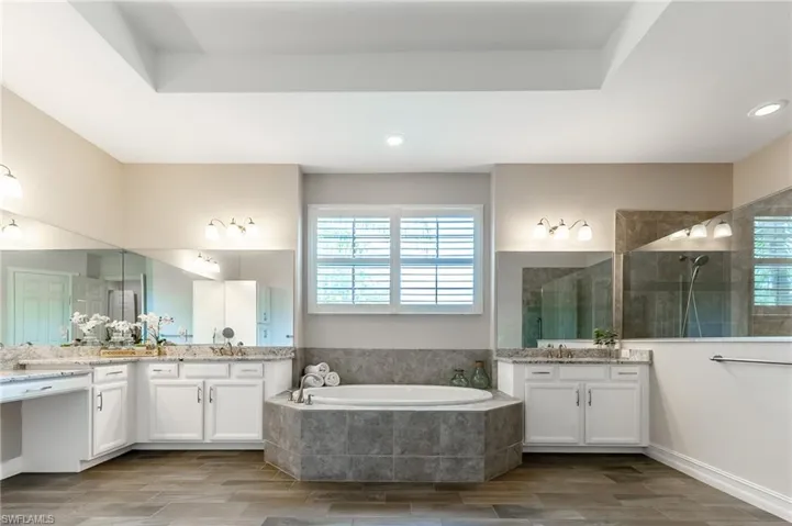 Large primary bathroom with soaking tub and walk-in shower