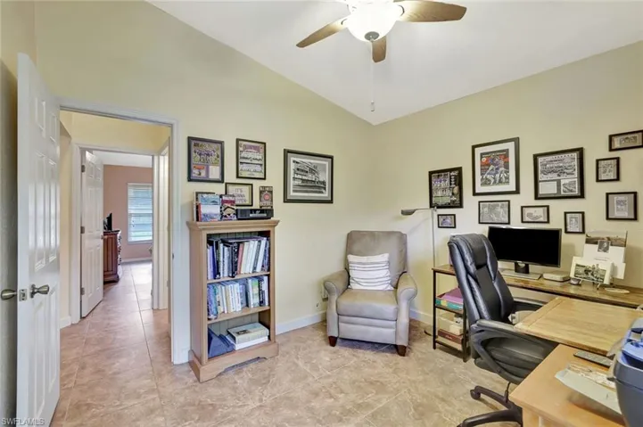 Office with vaulted ceiling, ceiling fan, and light tile patterned floors