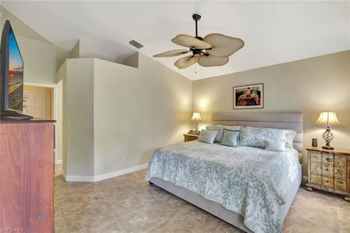 Bedroom featuring vaulted ceiling and ceiling fan