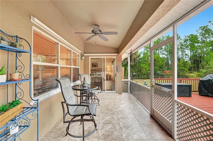 Sunroom featuring vaulted ceiling and a ceiling fan