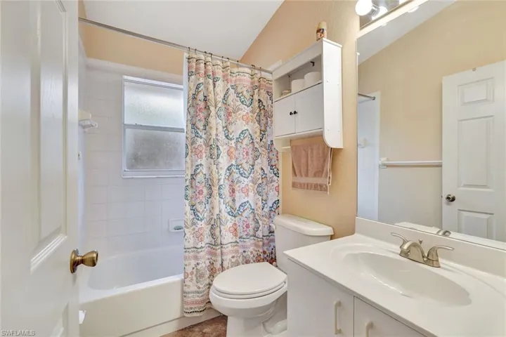 Bathroom featuring shower / tub combo and vanity
