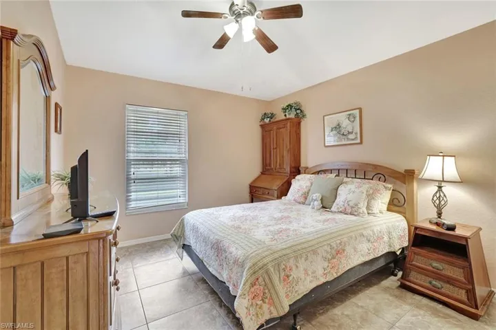Bedroom featuring light tile patterned floors and ceiling fan