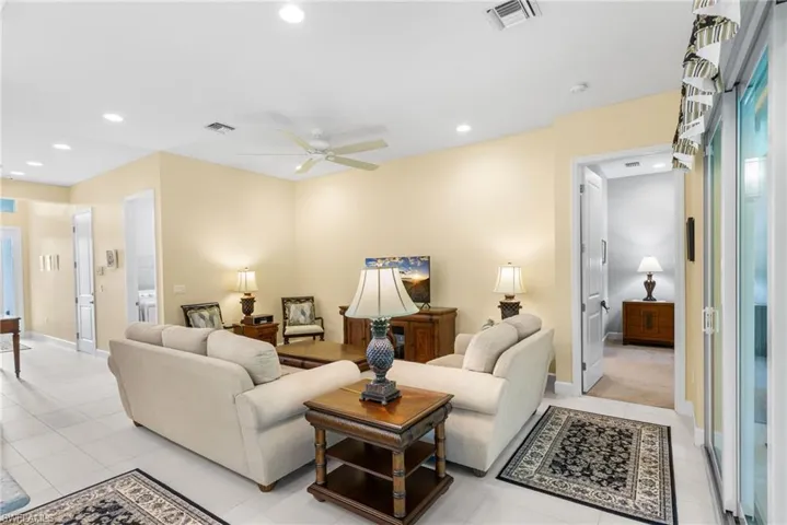 Living area featuring a ceiling fan, recessed lighting, and light tile patterned floors