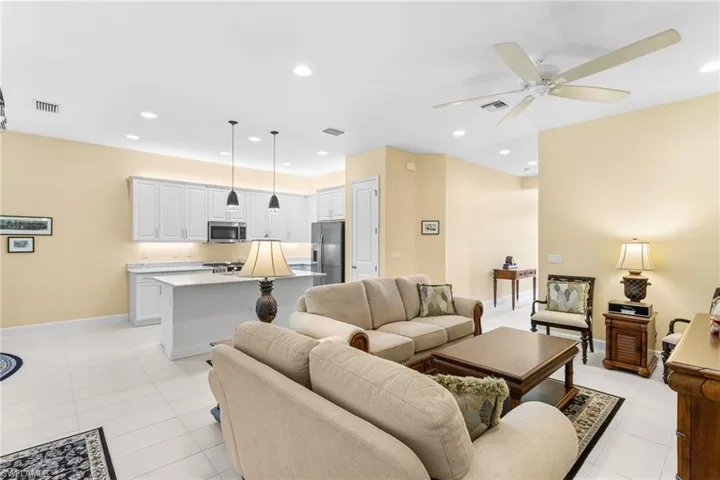 Living area featuring recessed lighting, light tile patterned floors, and a ceiling fan