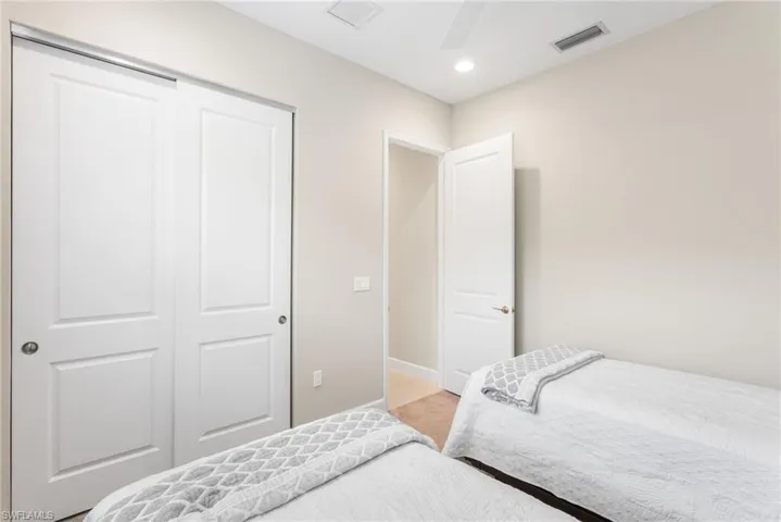 Bedroom with light carpet, a closet, ceiling fan, and recessed lighting