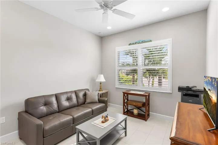Living room with recessed lighting and a ceiling fan