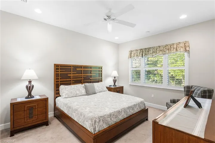 Bedroom featuring light carpet, a ceiling fan, and recessed lighting