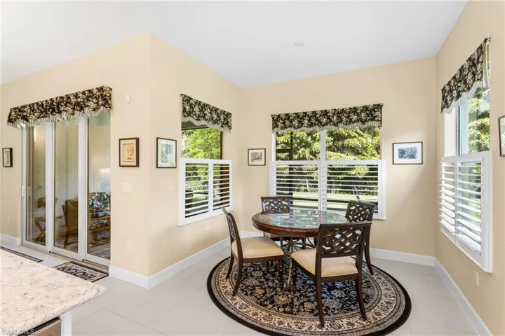 Dining area with baseboards and light tile patterned floors
