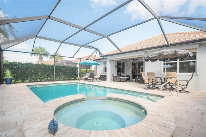 View of pool featuring an in ground hot tub, a patio, ceiling fan, and a lanai