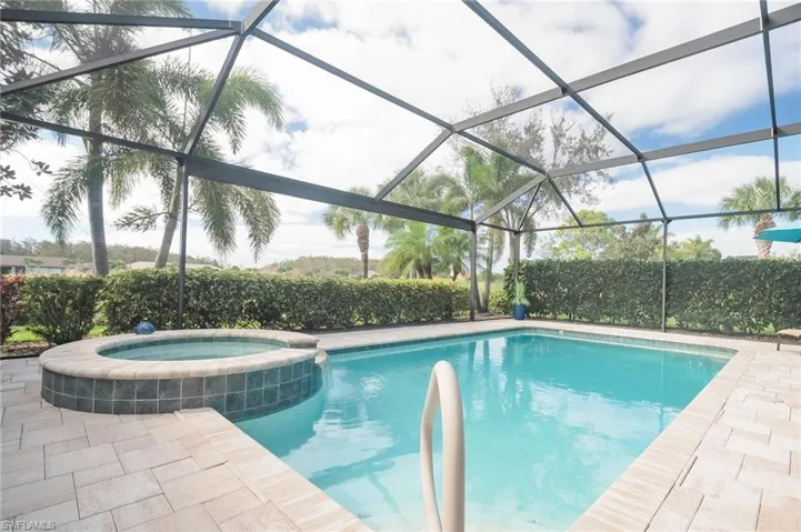 View of swimming pool featuring a lanai
