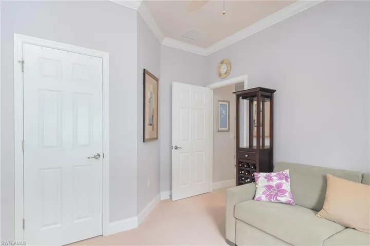 Carpeted living room with crown molding