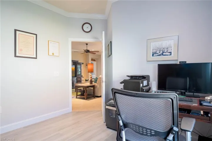 Home office featuring crown molding and light wood-type flooring