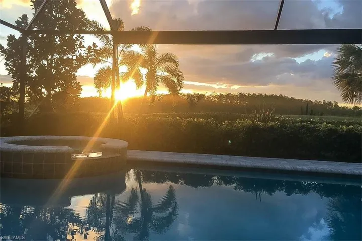 Pool at dusk with glass enclosure