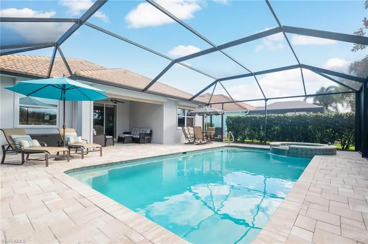 View of pool featuring an in ground hot tub, a lanai, and patio area