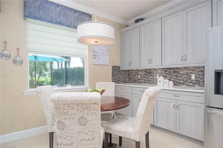 Tiled dining area featuring ornamental molding