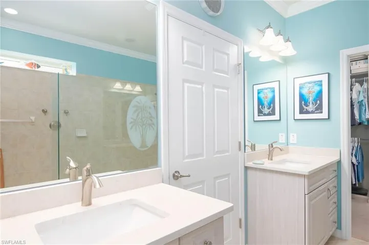 Bathroom with vanity and ornamental molding